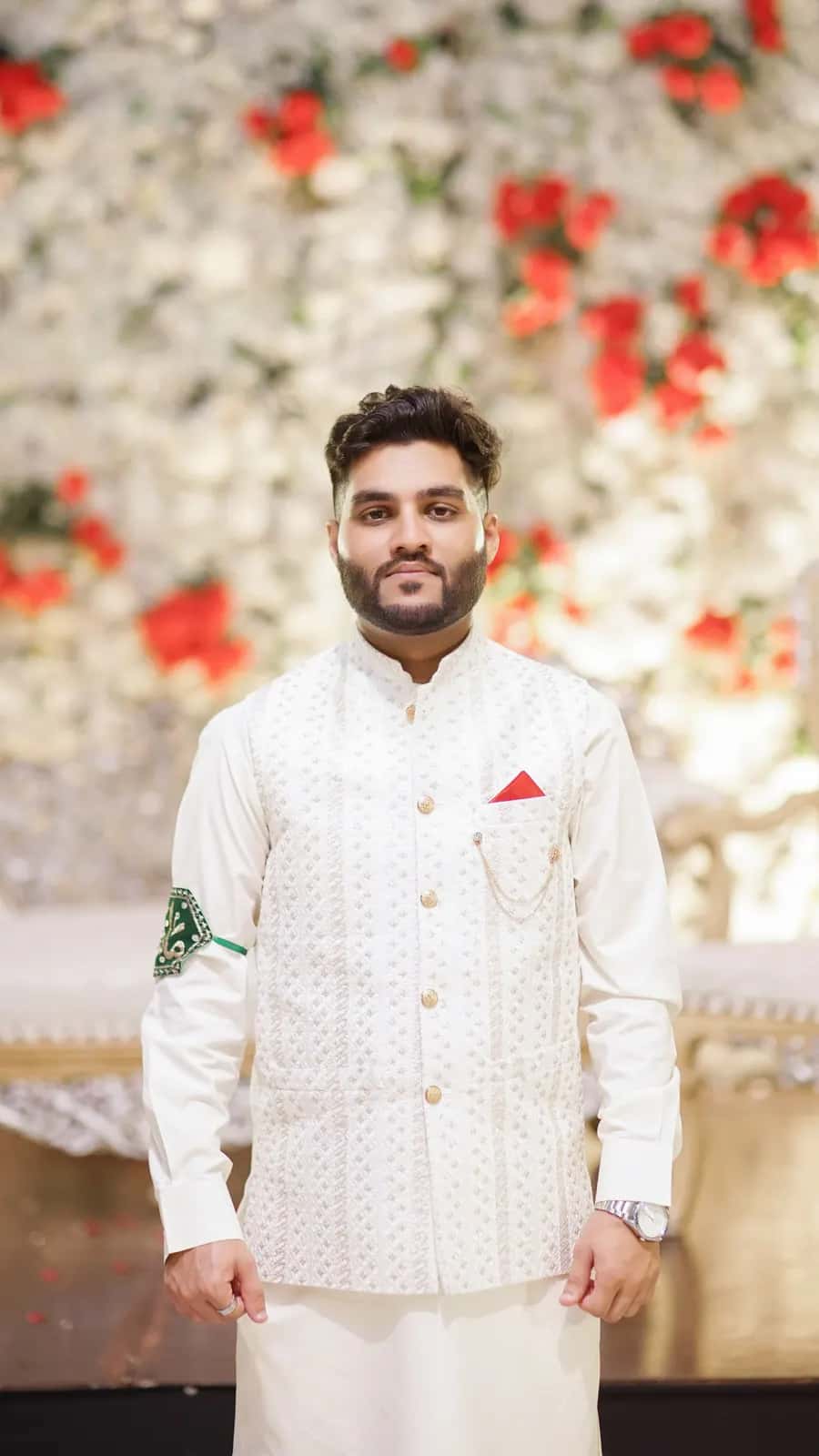 A groom celebrating on a decorated horse at his baraat