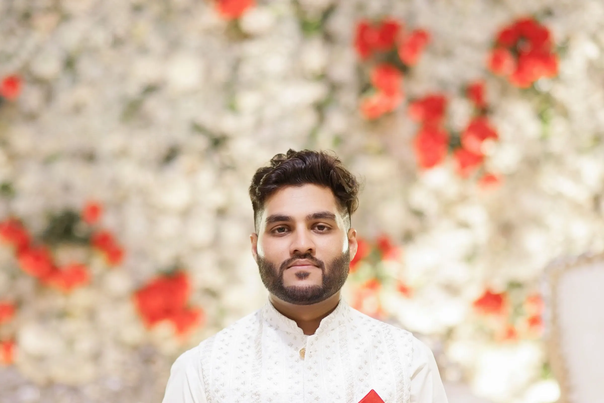 A groom celebrating on a decorated horse at his baraat