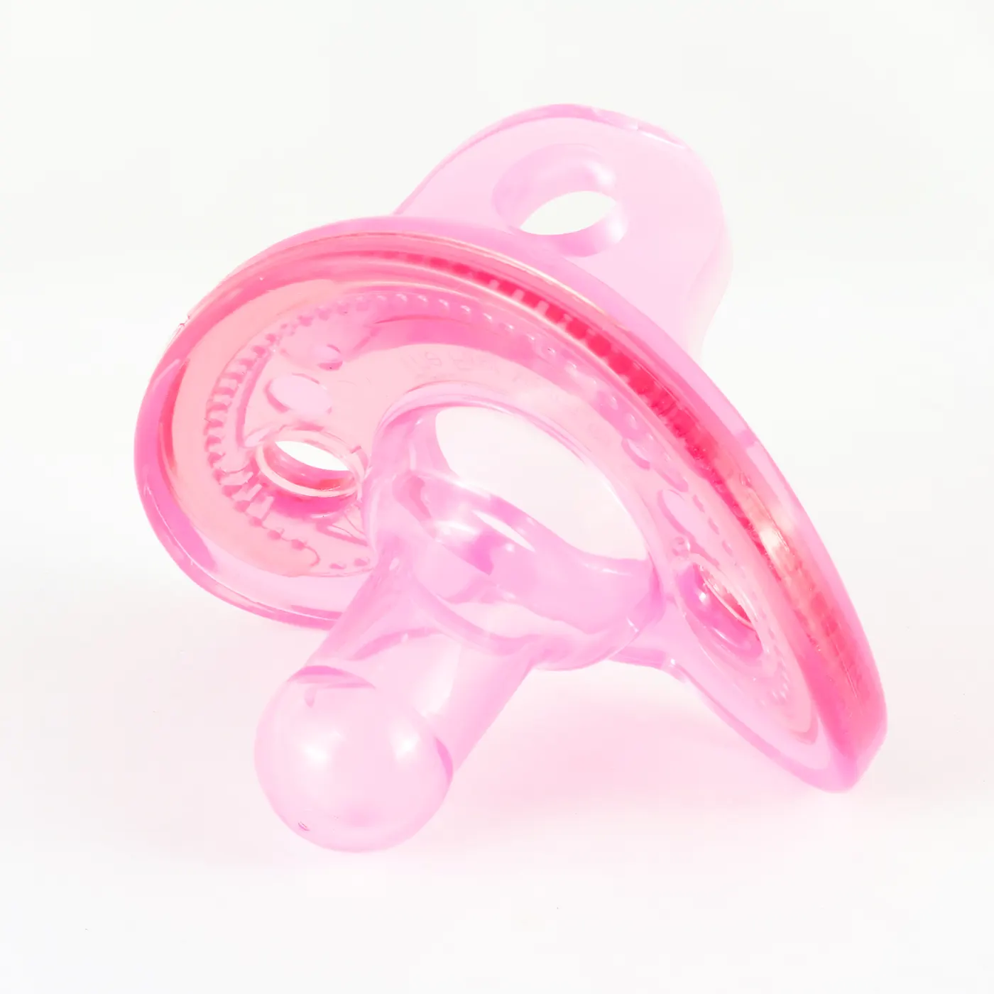 A pink silicone pacifier on a white background