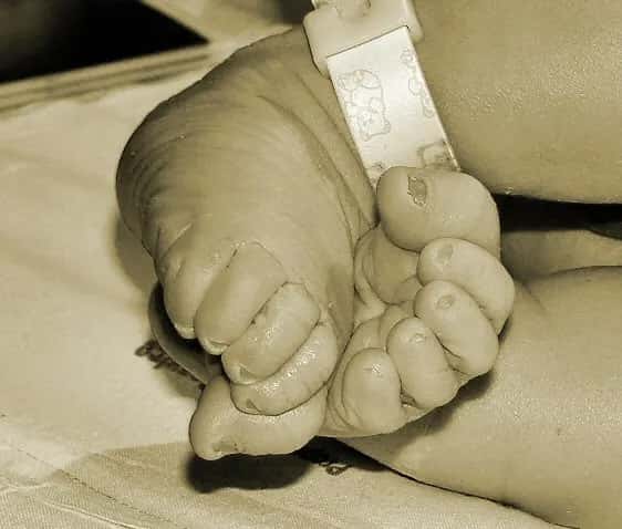 A newborn's tiny feet side by side