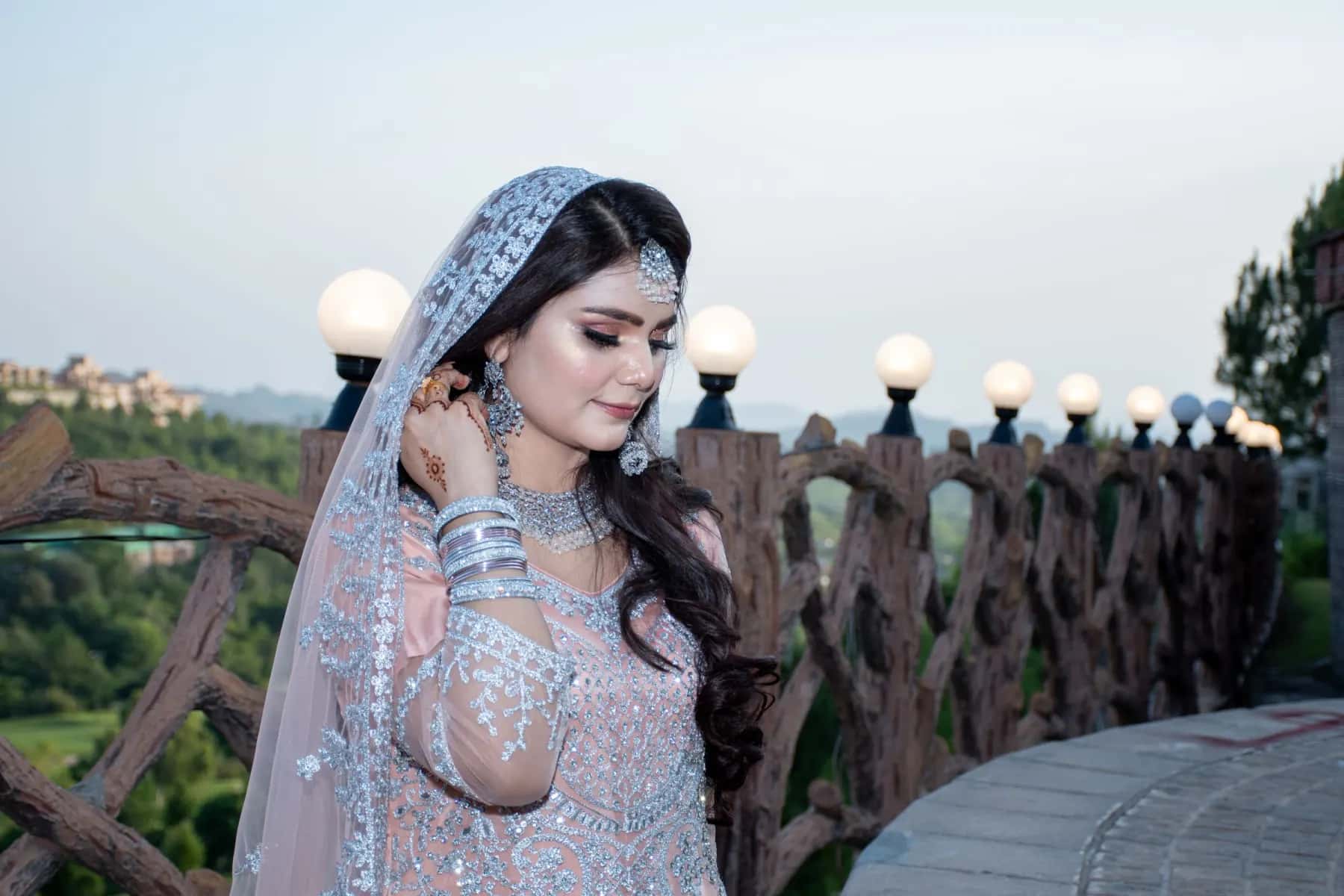 A bride in a silver veil on a terrace