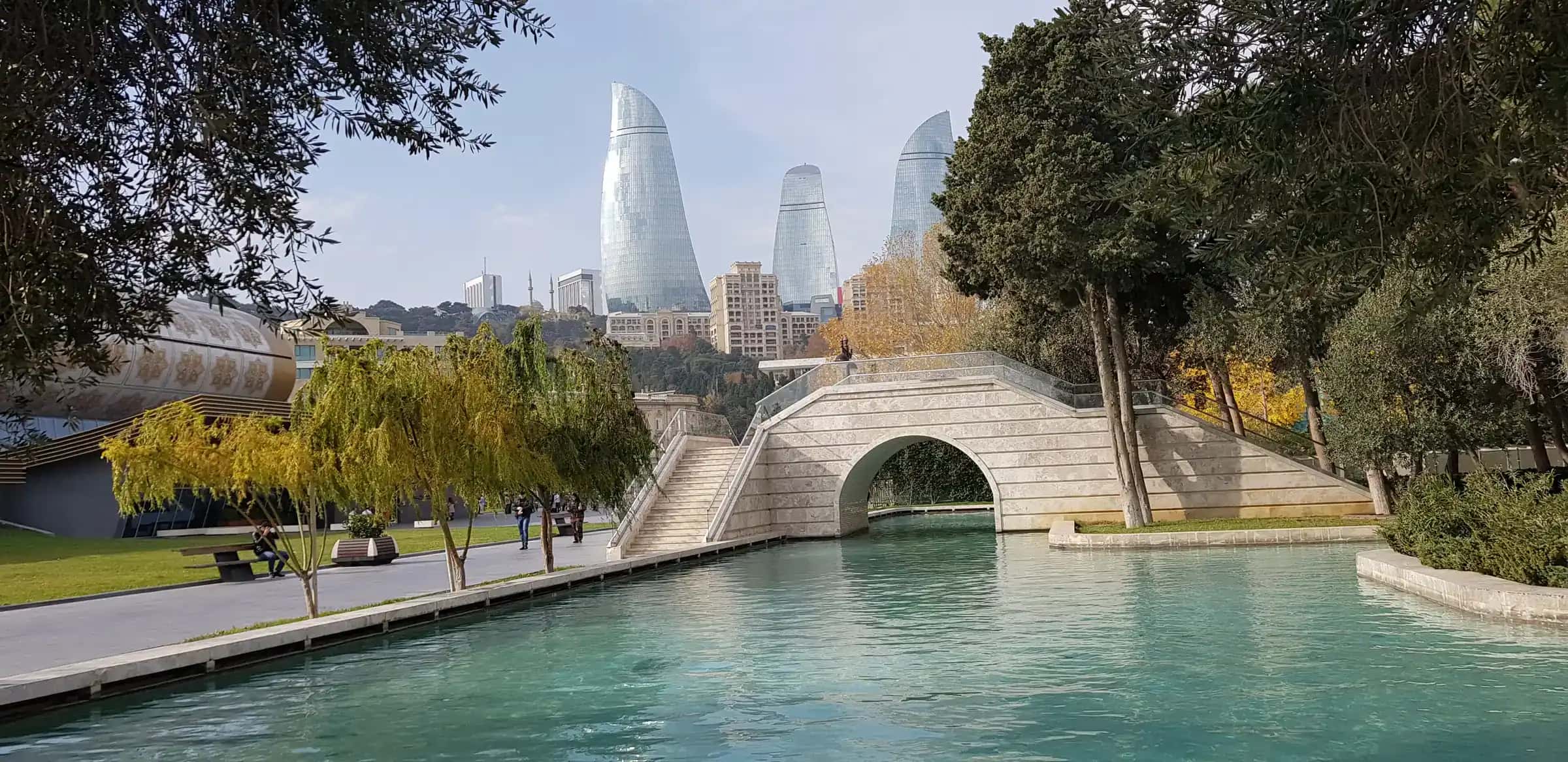 The canals of Little Venice on Baku Boulevard, the Flame Towers behind the trees