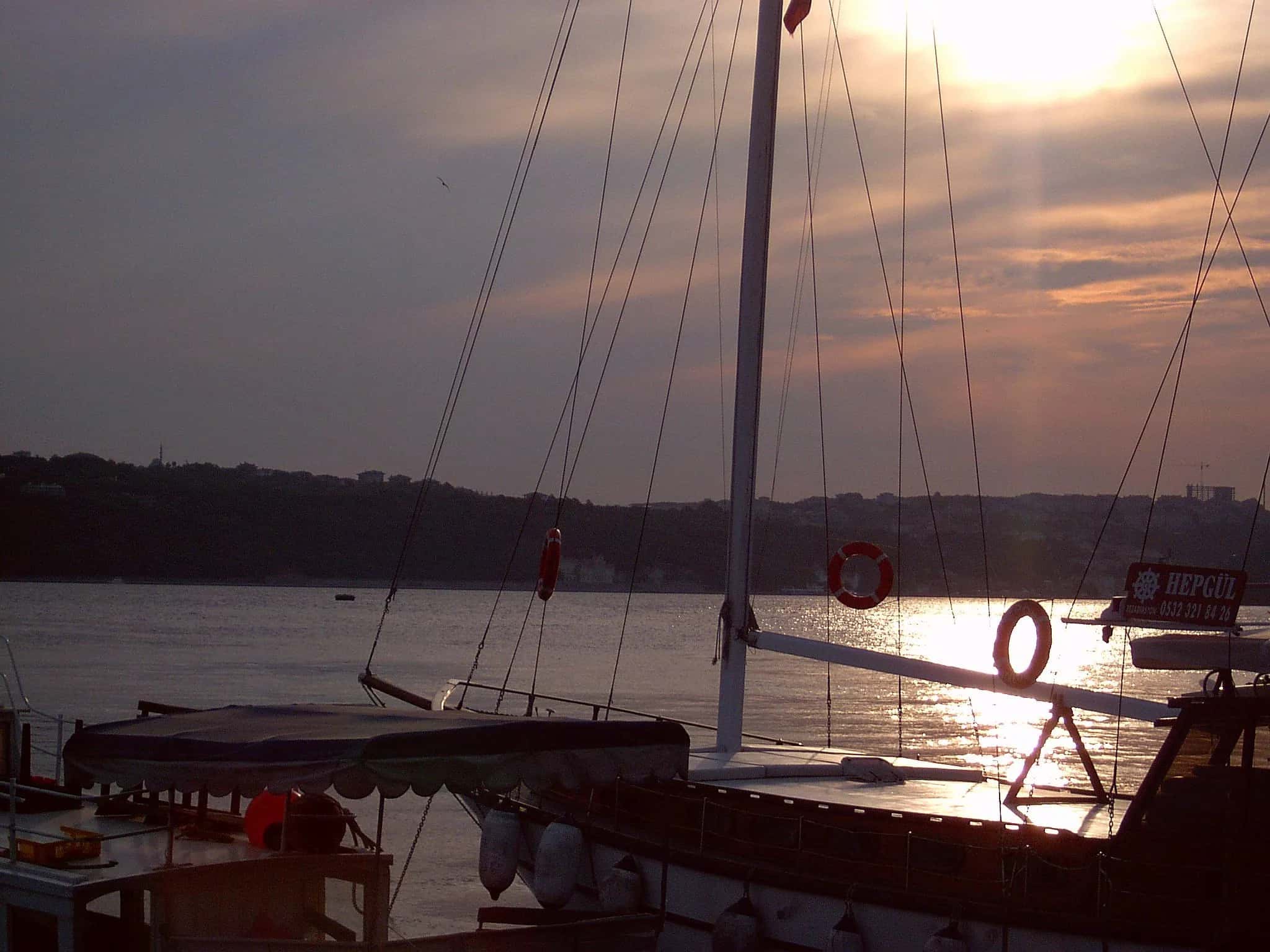 A sailing boat at anchor as the sun goes down