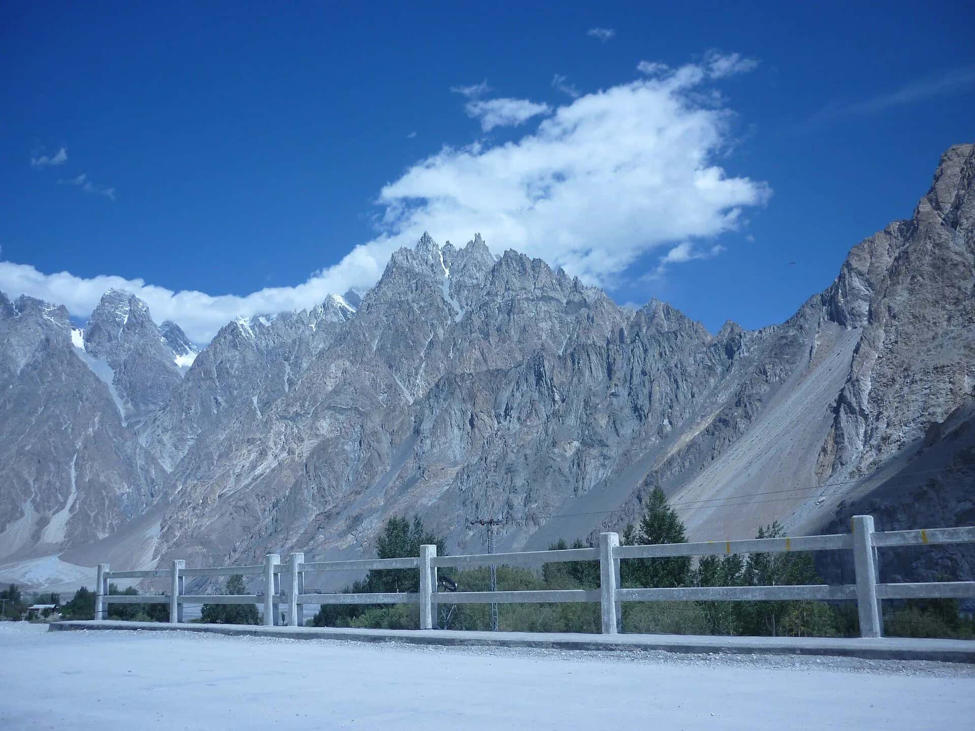 The Passu cones behind a roadside fence