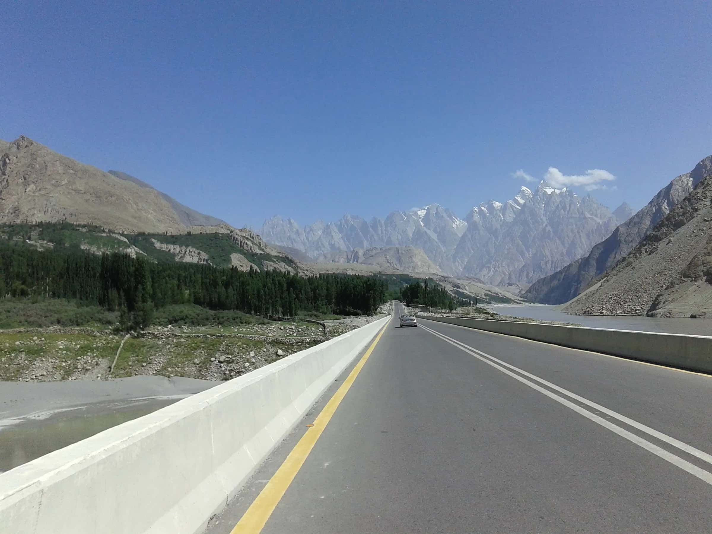 The Karakoram Highway running straight toward the Passu cones