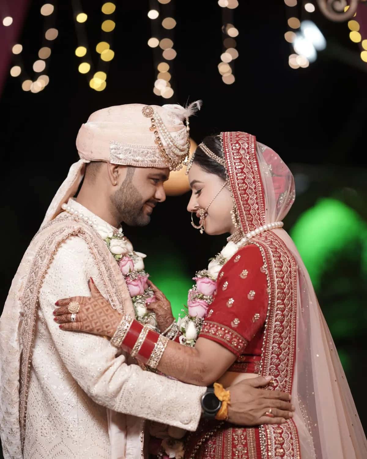 The bride and groom resting their foreheads together