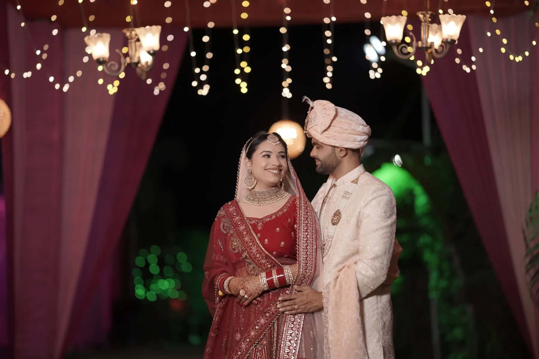 The groom spinning his bride on a leafy path at night