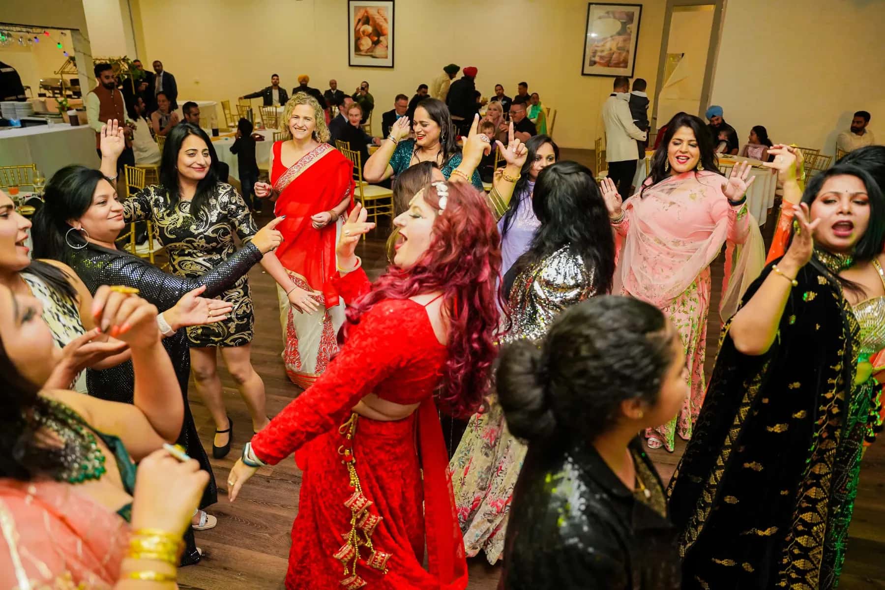 Aunties and cousins dancing together in a crowded hall