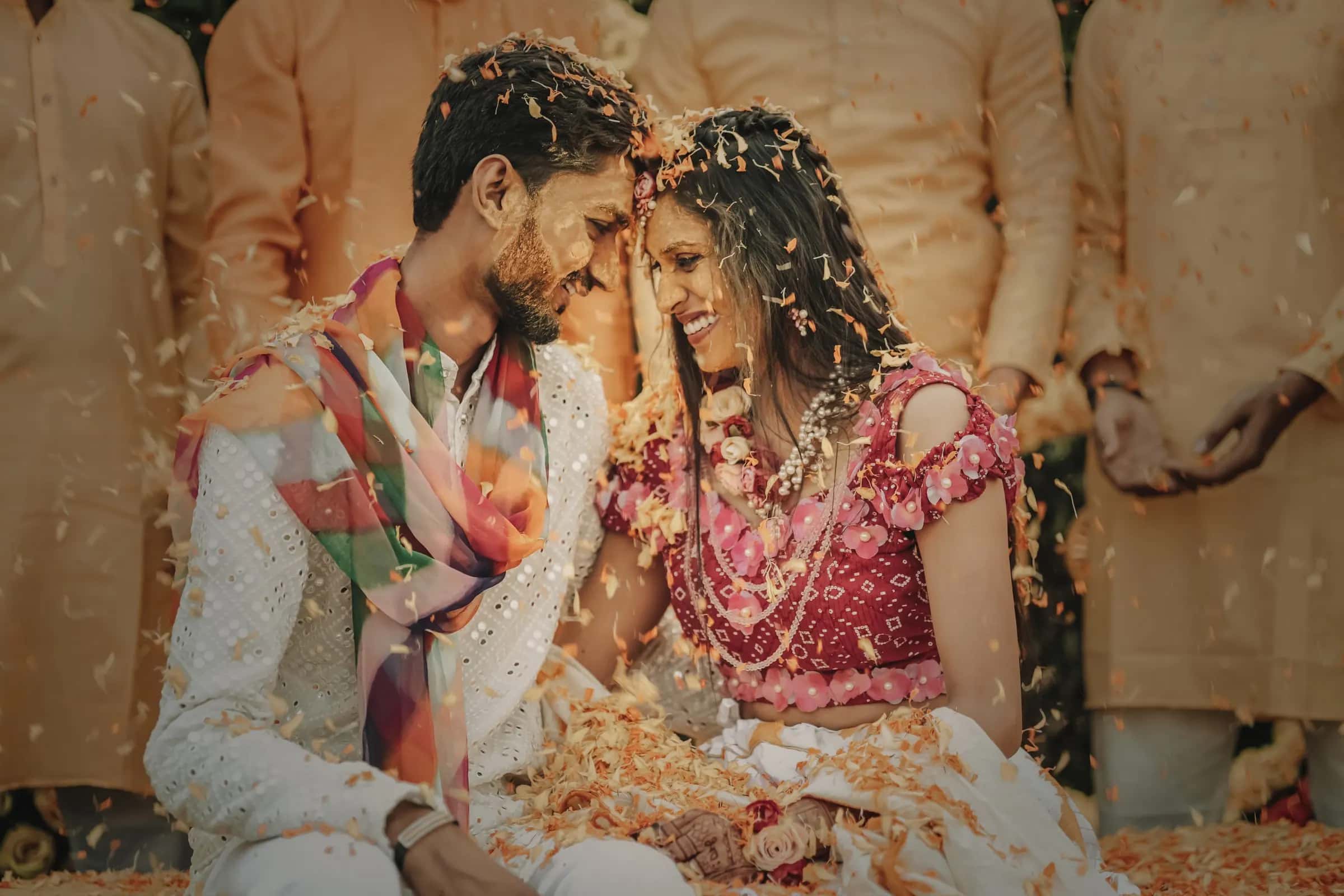 A friend showering yellow petals over the couple