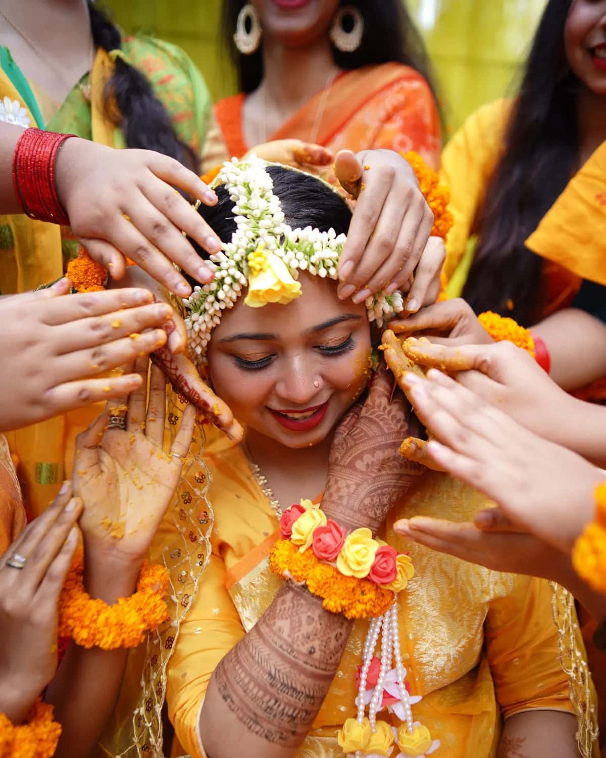 Hands decorating the bride's hair with flowers