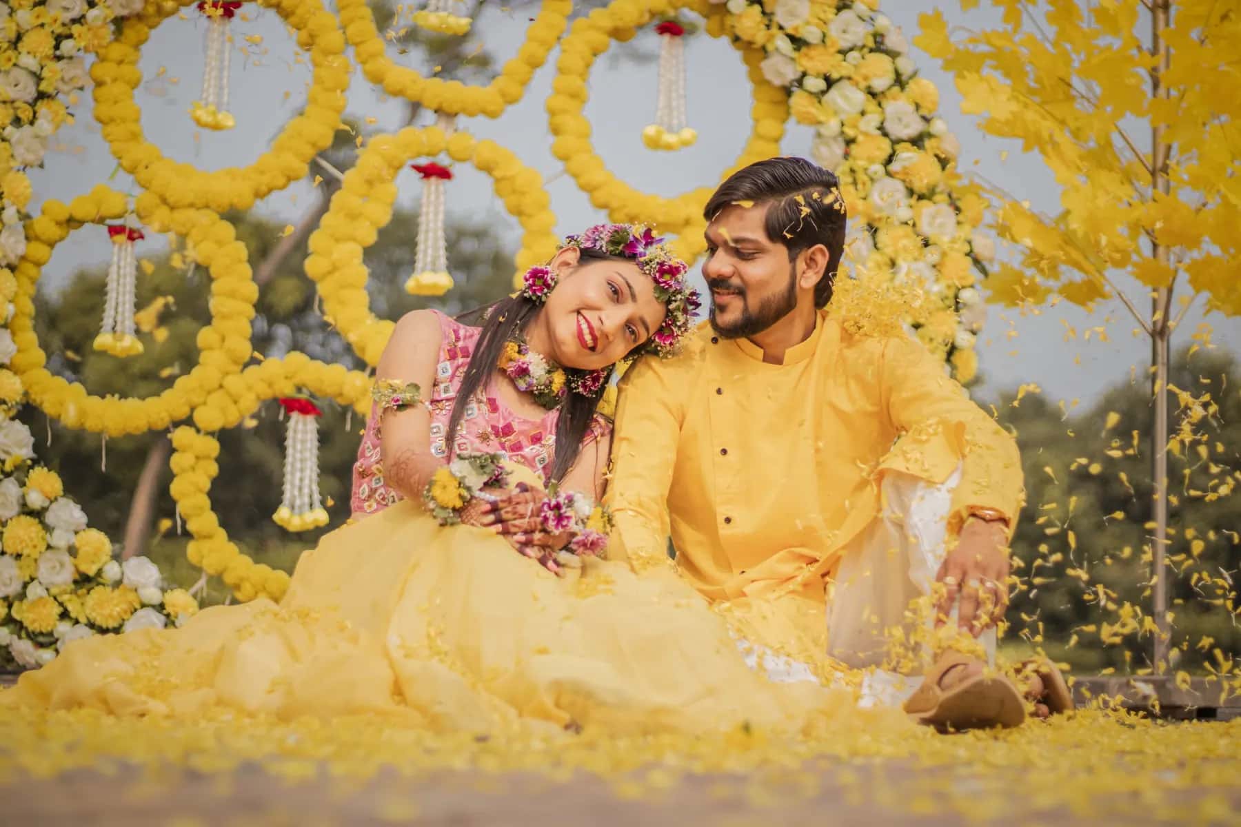 The couple in yellow surrounded by marigold rings