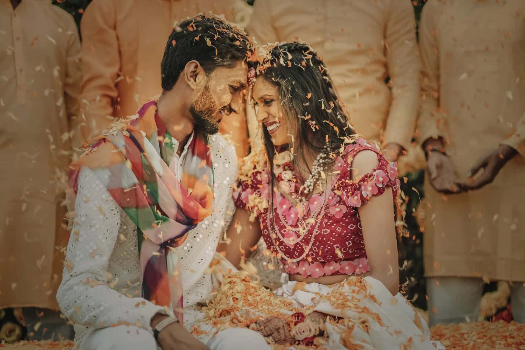 The couple laughing under falling petals